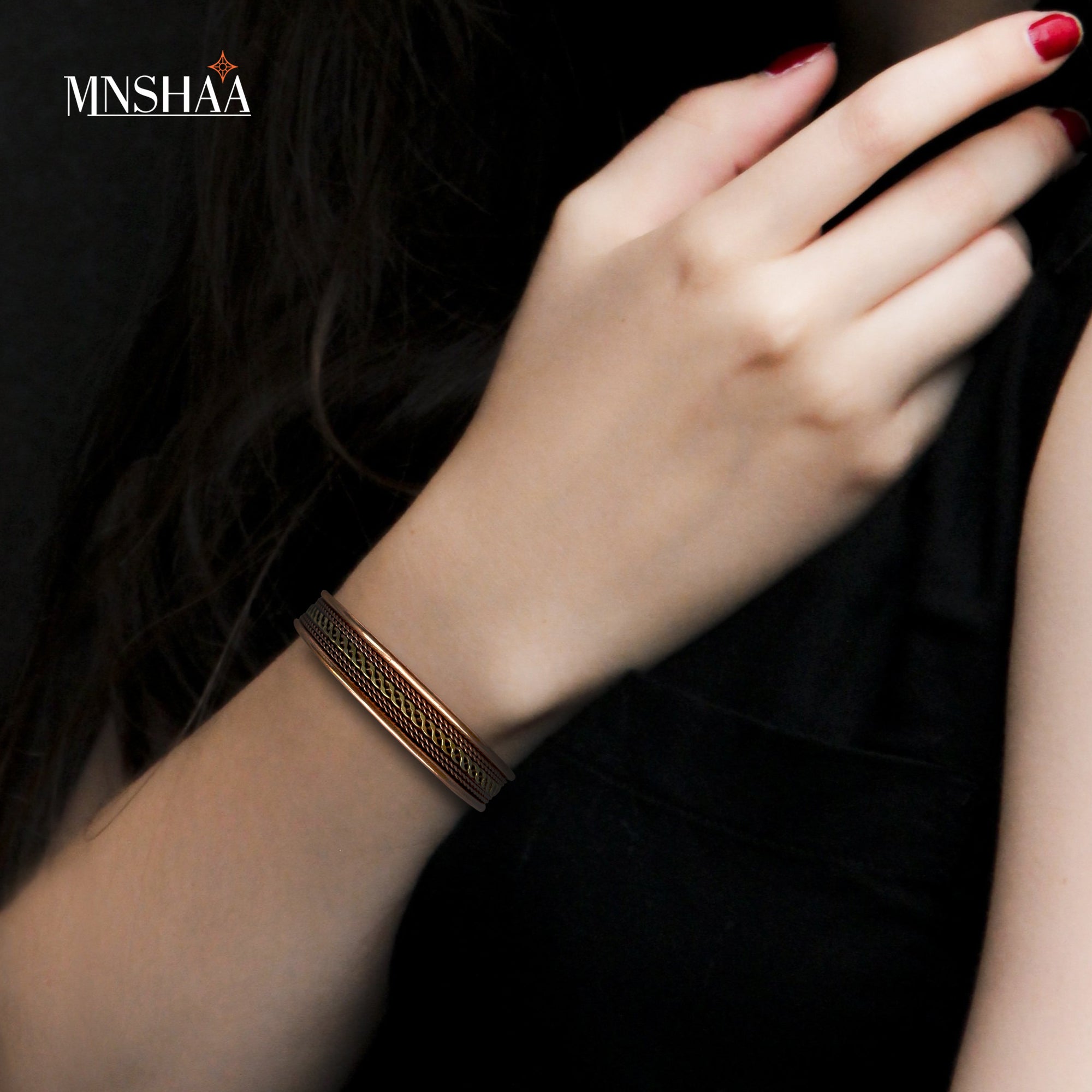 Image of a lady's hand wearing Mnshaa Copper Bracelet. Mnshaa adjustable magnetic copper bracelet for men and women is thought to promote general health by accelerating body's natural healing process. This bracelet is handmcrafted. A perfect gift for people you love. Suitable gift of care for all occasions like Birthday, Anniversary, Valentine's Day, Father's day, Christmas, Mother's Day, etc.
