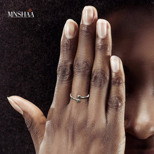 An image of a lady's hand wearing Mnshaa reaching out silver ring. Aesthetically designed 925 sterling silver handmade adjustable ring.Suitable for all occasions. Rhodium plating makes it less prone to tarnish. Completely hypoallergenic, allergy-free, nickel-free jewellery. Use as finger ring, above-knuckle ring, thumb band, stacking rings, stopper ring, mid finger ring or toe ring. Ideal Christmas gift all age groups. Beautifully packed in gift box.