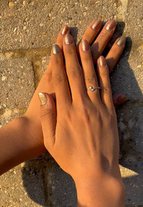 An image of lady's hand one above another wearing Mnshaa reaching out silver ring. Aesthetically designed 925 sterling silver handmade adjustable ring. It is small, simple, delicate, elegant, light weight. Suitable for all occasions. Use as finger ring, above-knuckle ring, thumb band, stacking rings, stopper ring, mid finger ring or toe ring.  Ideal Christmas gift all age groups - teenage girls to mature ladies. Unique ring beautifully packaged in jewellery bag & box. 