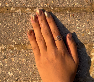 An image of lady's hand wearing 2 Mnshaa reaching out silver ring. This ring can be stacked to make a statement. Aesthetically designed 925 sterling silver handmade adjustable ring.Suitable for all occasions. Rhodium plating makes it less prone to tarnish. Completely hypoallergenic, allergy-free, nickel-free jewellery. Use as finger ring, above-knuckle ring, thumb band, stacking rings, stopper ring, mid finger ring or toe ring. Ideal Christmas gift all age groups. Beautifully packed in gift box.